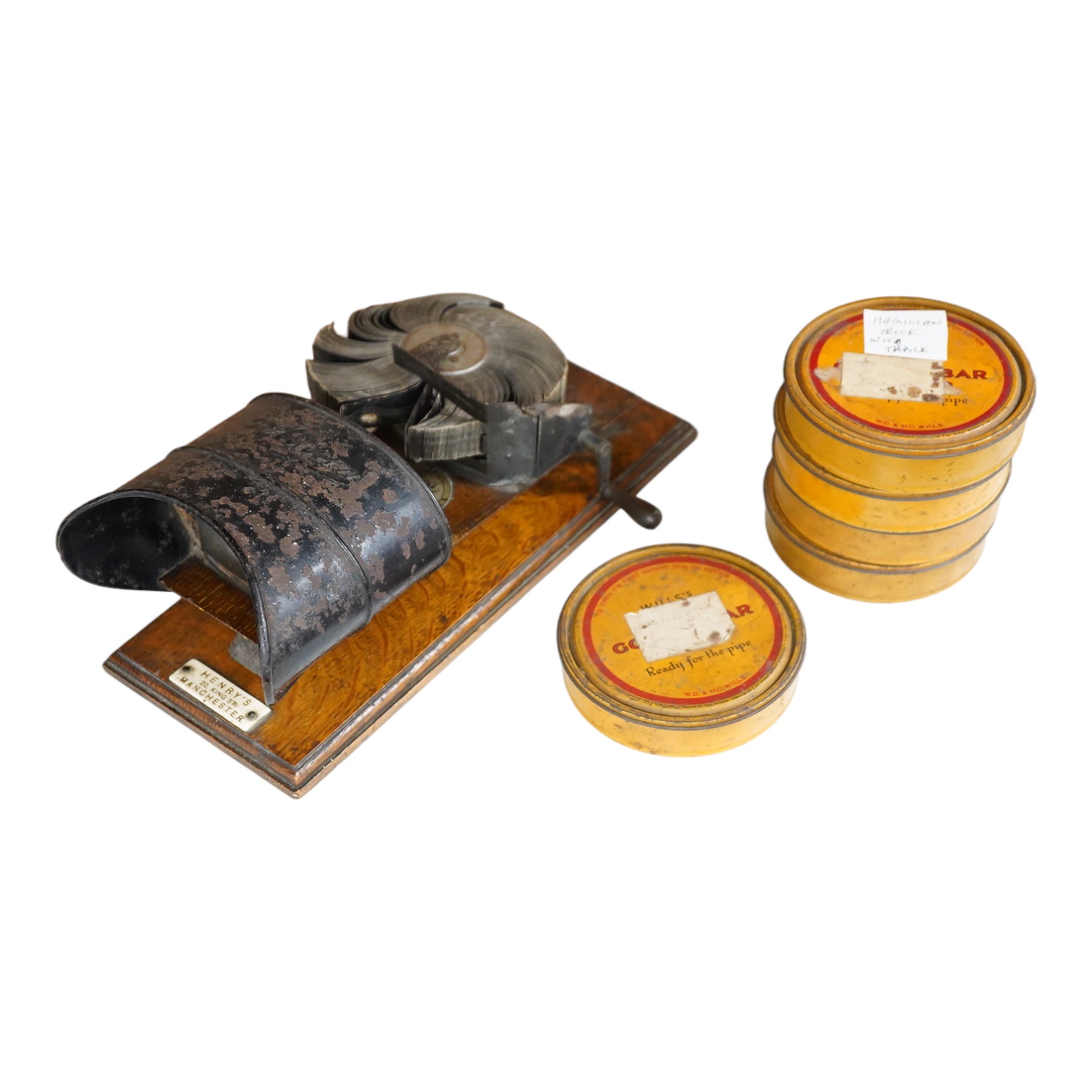 An early 20th century Kinora cinematographic viewer by Bond’s Ltd., 138 New Bond Street, c.1910, with six reels of flip card picture films, black painted steel and oak construction, with an ivory retail label for Henry’s